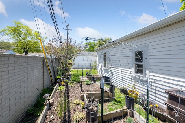 view of yard with a garden and fence