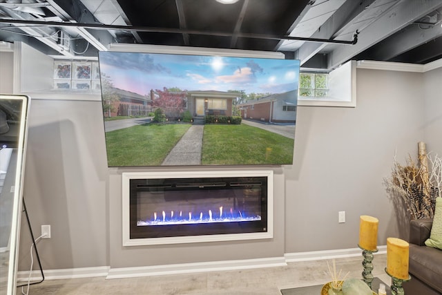 detailed view of baseboards and a glass covered fireplace