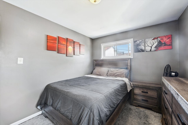 carpeted bedroom featuring baseboards