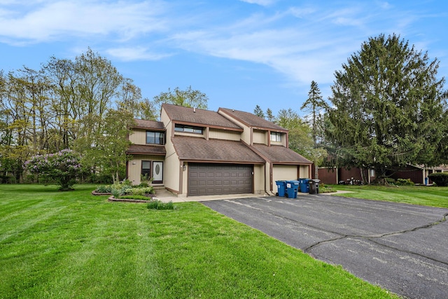 view of front of home featuring a front lawn, stucco siding, driveway, and an attached garage