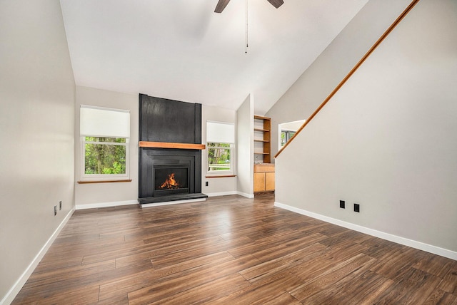 unfurnished living room featuring baseboards, a fireplace, ceiling fan, and wood finished floors