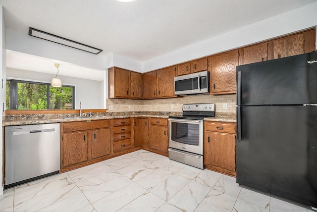 kitchen with brown cabinetry, marble finish floor, stainless steel appliances, and a sink