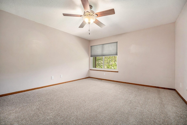 unfurnished room with a textured ceiling, visible vents, baseboards, ceiling fan, and light colored carpet
