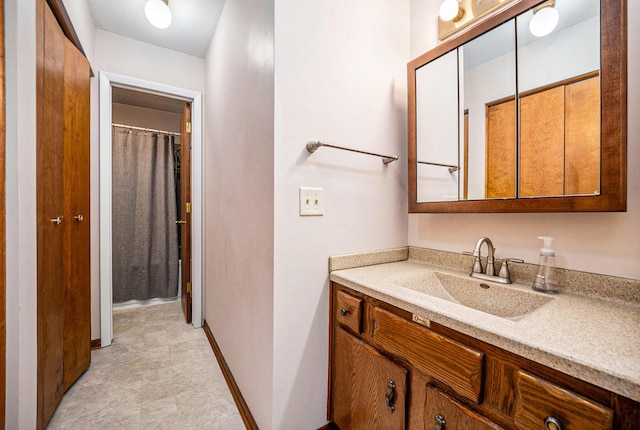 bathroom featuring vanity and baseboards