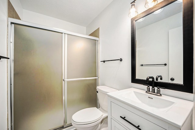 bathroom featuring vanity, toilet, and a shower stall