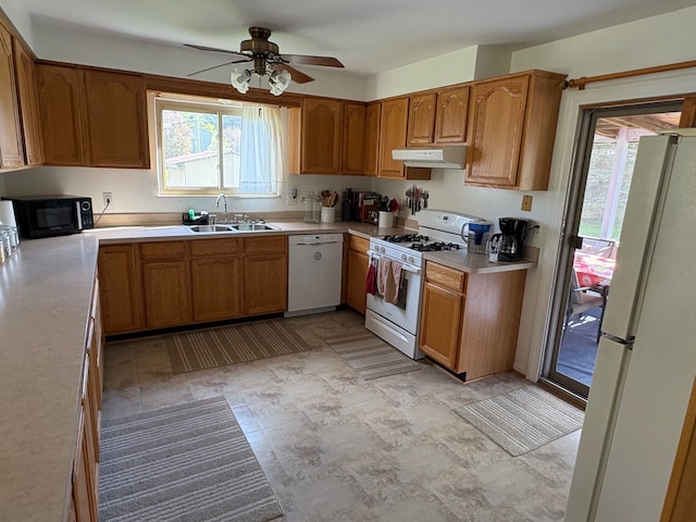 2725 Ormond Rd, White Lake, MI 48383 - kitchen with white appliances, a sink, range hood, and plenty of natural light