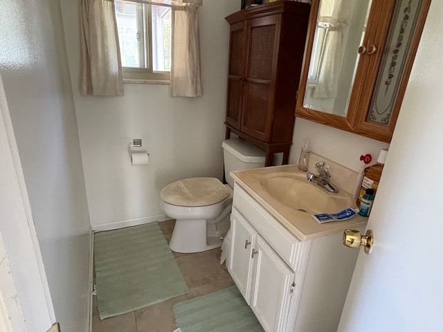 2725 Ormond Rd, White Lake, MI 48383 - bathroom with toilet, baseboards, tile patterned flooring, and vanity