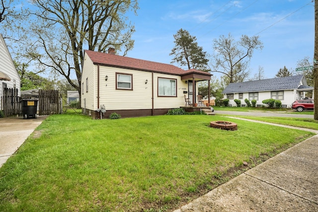 view of front of home with a chimney and a fire pit