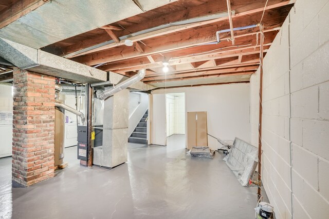 unfinished below grade area with concrete block wall and stairway