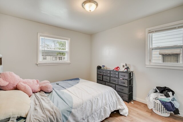 bedroom with wood finished floors and baseboards