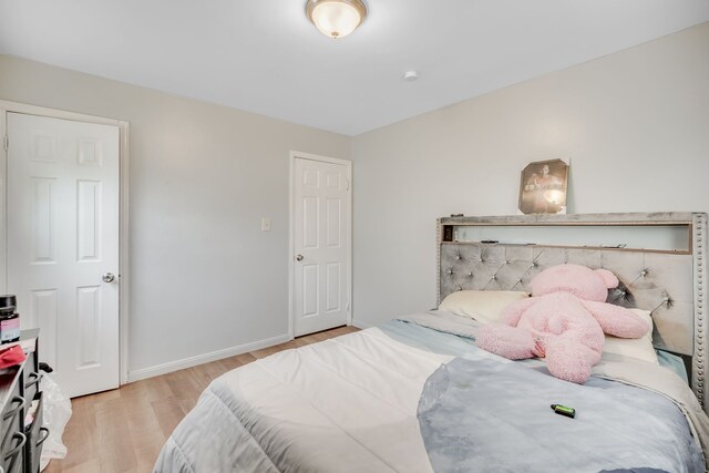 bedroom featuring light wood-type flooring and baseboards