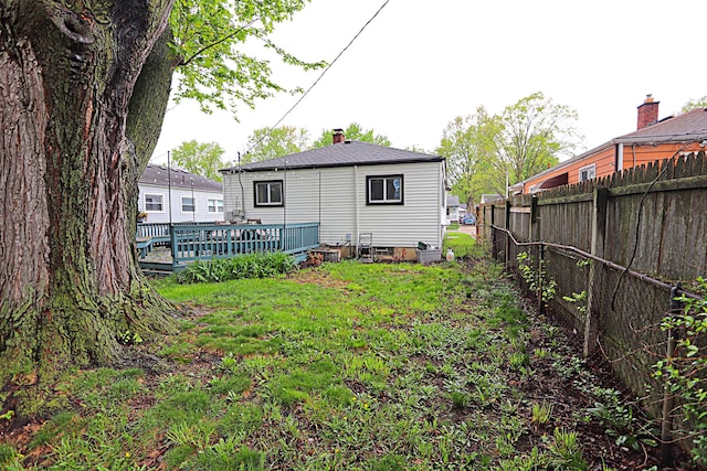 rear view of house featuring a deck and a chimney