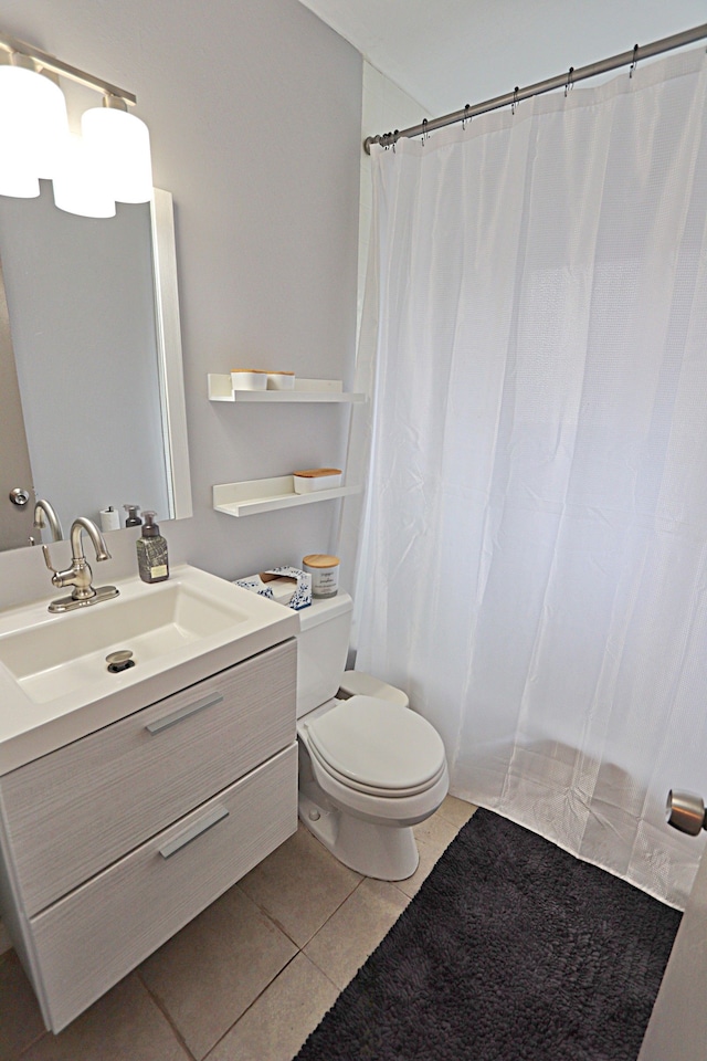 full bathroom featuring tile patterned flooring, toilet, and vanity