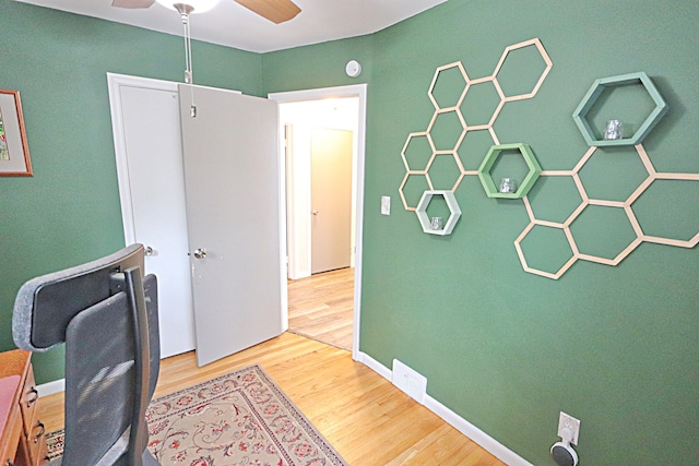 office featuring wood finished floors and a ceiling fan