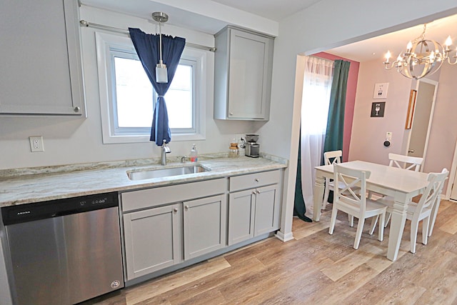 kitchen with dishwasher, light wood-style floors, a chandelier, a sink, and pendant lighting