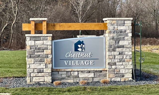 community / neighborhood sign with a lawn