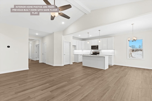 unfurnished living room with ceiling fan, light wood-style flooring, a chandelier, recessed lighting, and baseboards