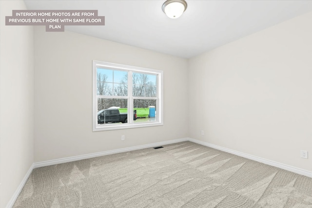 empty room with carpet floors and baseboards