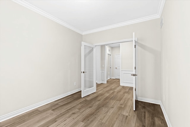 unfurnished bedroom featuring light wood-type flooring, crown molding, and baseboards