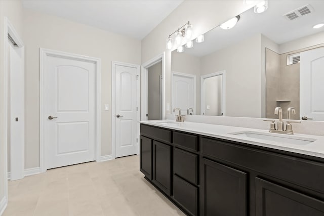 bathroom featuring double vanity and baseboards