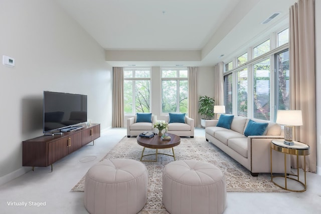 living room with light colored carpet, baseboards, and visible vents