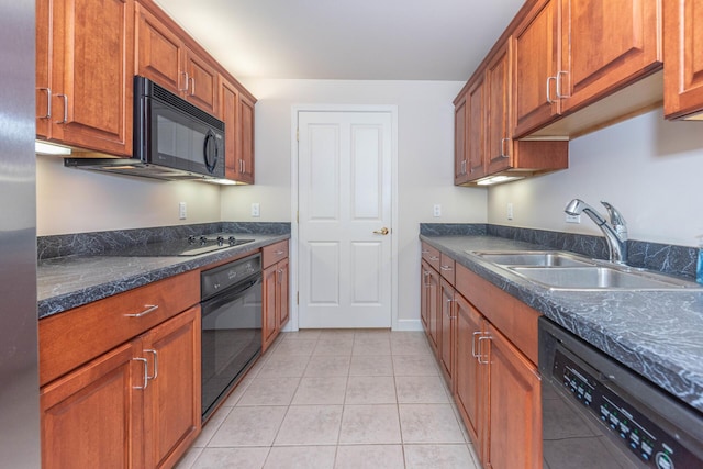 kitchen with black appliances, brown cabinets, light tile patterned flooring, and a sink