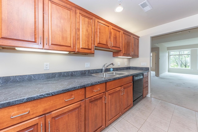 kitchen with a sink, brown cabinetry, black dishwasher, light carpet, and light tile patterned floors