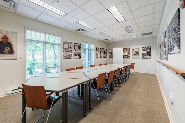 dining area featuring baseboards, a drop ceiling, carpet flooring, and visible vents