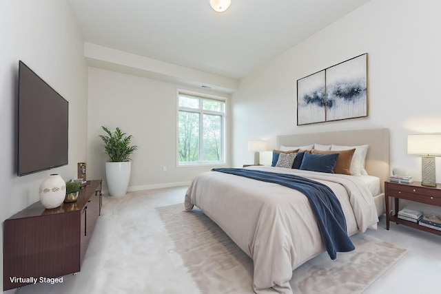 bedroom featuring baseboards and light carpet