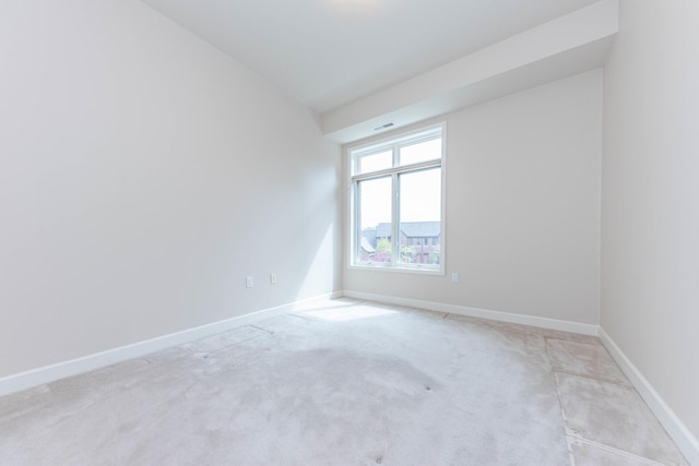 unfurnished room featuring carpet floors, baseboards, and visible vents