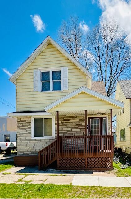 505 Ramsdell St, Manistee, MI 49660 - view of front of property with a porch and stone siding