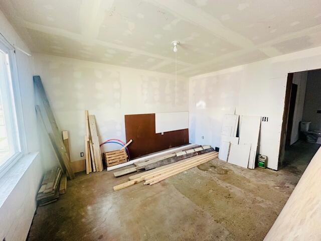 505 Ramsdell St, Manistee, MI 49660 - empty room featuring plenty of natural light and concrete flooring
