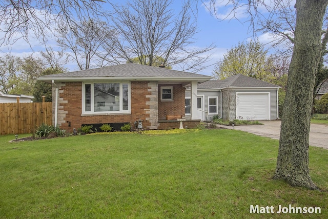 view of front of property with driveway, brick siding, fence, a garage, and a front lawn