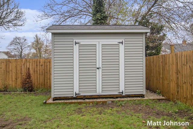 view of shed with a fenced backyard