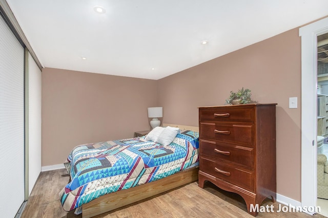 bedroom with baseboards and wood finished floors