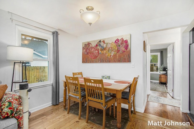 dining area featuring baseboards and light wood-style floors