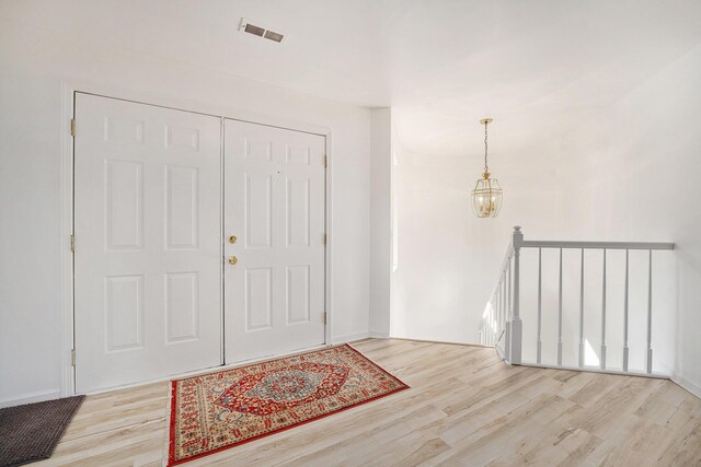 44811 Paw Paw Rd, Paw Paw, MI 49079 - entrance foyer with a chandelier, visible vents, and wood finished floors