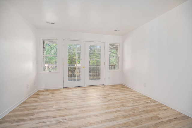 44811 Paw Paw Rd, Paw Paw, MI 49079 - empty room featuring light wood finished floors, baseboards, french doors, and visible vents