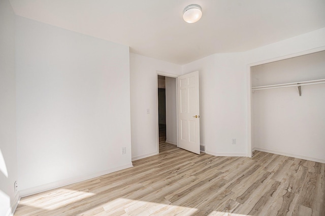44811 Paw Paw Rd, Paw Paw, MI 49079 - unfurnished bedroom featuring a closet, wood finished floors, and baseboards