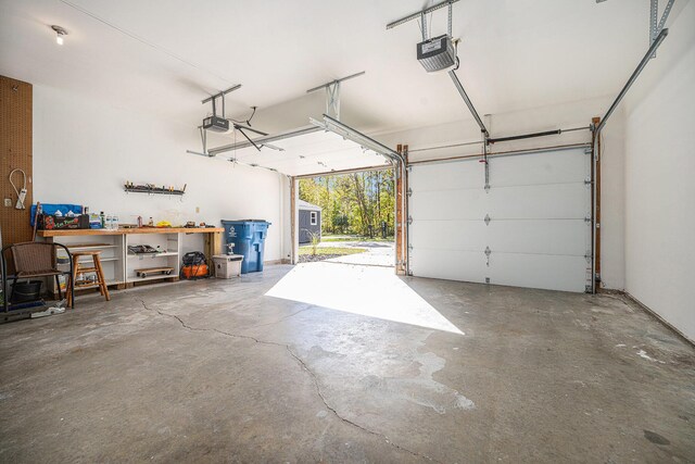 44811 Paw Paw Rd, Paw Paw, MI 49079 - garage with a workshop area and a garage door opener