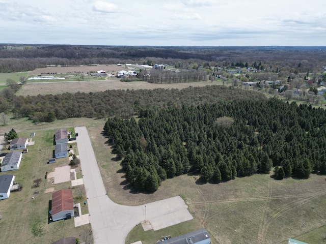 birds eye view of property featuring a wooded view