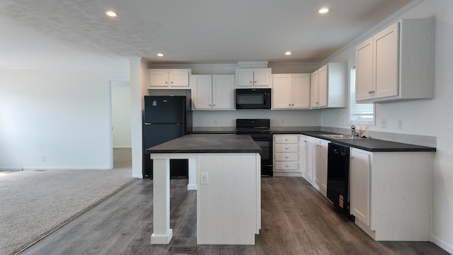 kitchen with white cabinetry, black appliances, dark countertops, and a sink