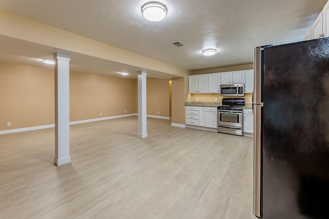 9379 Cook St, Montague, MI 49437 - kitchen with stainless steel appliances, light wood-style floors, white cabinets, open floor plan, and baseboards