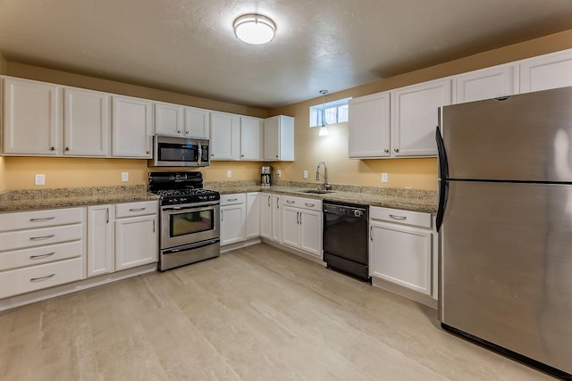 9379 Cook St, Montague, MI 49437 - kitchen with stainless steel appliances, white cabinetry, a sink, and light wood finished floors