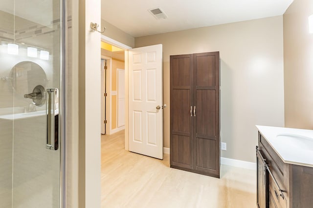 9379 Cook St, Montague, MI 49437 - bathroom with vanity, a stall shower, wood finished floors, and baseboards