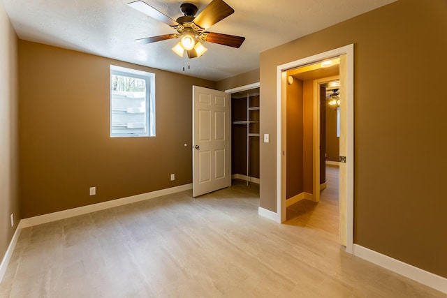 9379 Cook St, Montague, MI 49437 - unfurnished bedroom featuring light wood-style flooring, baseboards, a closet, and ceiling fan