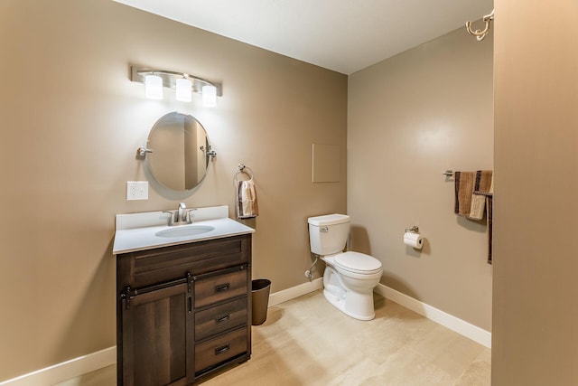 9379 Cook St, Montague, MI 49437 - bathroom featuring baseboards, vanity, and toilet