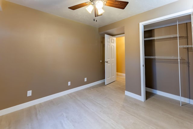9379 Cook St, Montague, MI 49437 - unfurnished bedroom with light wood-type flooring, baseboards, a closet, and a ceiling fan