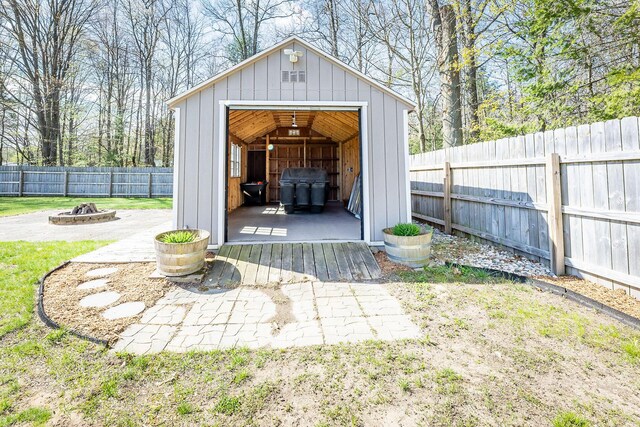 9379 Cook St, Montague, MI 49437 - view of outdoor structure featuring a fire pit and a fenced backyard