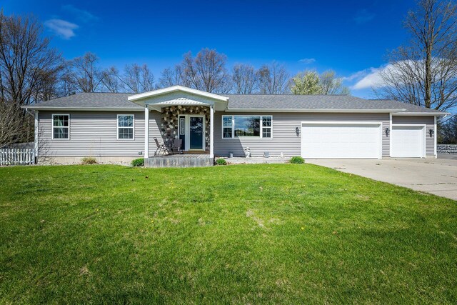 9379 Cook St, Montague, MI 49437 - ranch-style home featuring an attached garage, a front lawn, driveway, and a shingled roof